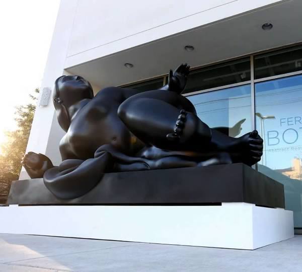 “Reclining Woman with Fruit" sculpture by Fernando Botero